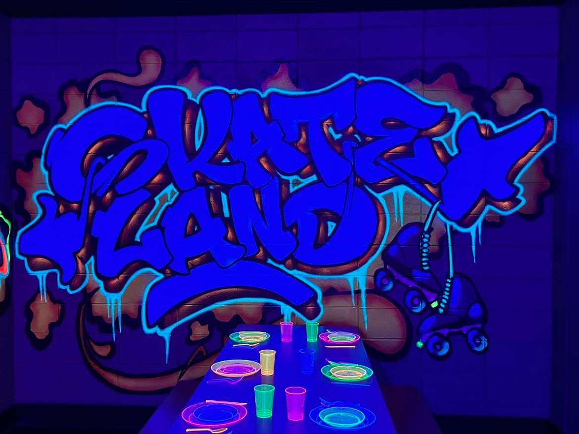 Blacklight Skate Land mural with glowing table