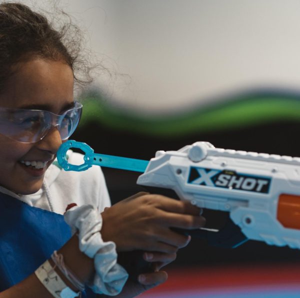 Girl wearing goggles aiming X-Shot toy blaster